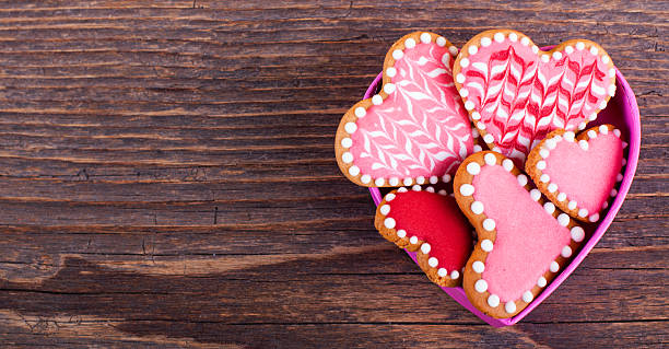 istock Valentine's cookies in a heart shape box on wooden table 630041600