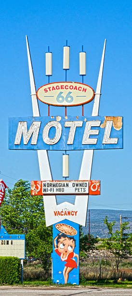 Seligman, United States - September 4, 2016: Another leftover from the heydays of Route 66 are several businesses that are still in operation today.  They've retained their kitschy 1950's look, as well.  Here is a classic:  the sign for the Stagecoach 66 Motel, complete wiht Betty Boop holding a pizza!