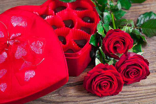 istock Heart chocolate box and red roses on wooden rustic background 630041940