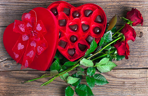 istock Heart chocolate box and red roses on wooden rustic background 630051562