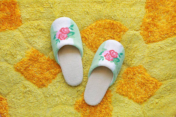 istock house slippers on yellow - orange Carpet background 630066174
