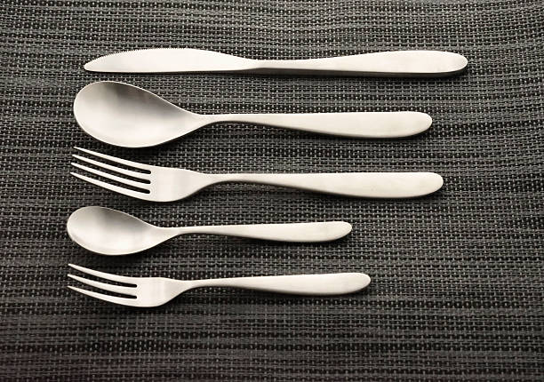 istock contemporary silver cutlery set neatly lined 630066552