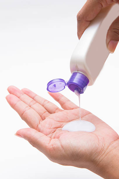 istock woman pouring body lotion on hand 630068370