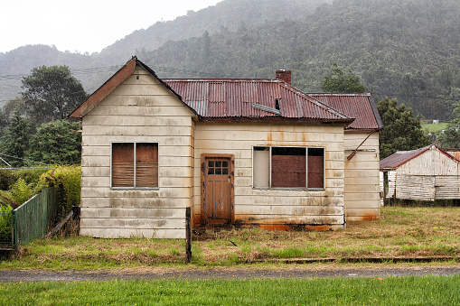 Old abandoned weatherboard home and shed in Queenstown, TasmaniaOld abandoned weatherboard home and shed in Queenstown, Tasmania