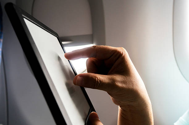 istock people reading ebook on airplane 630619544