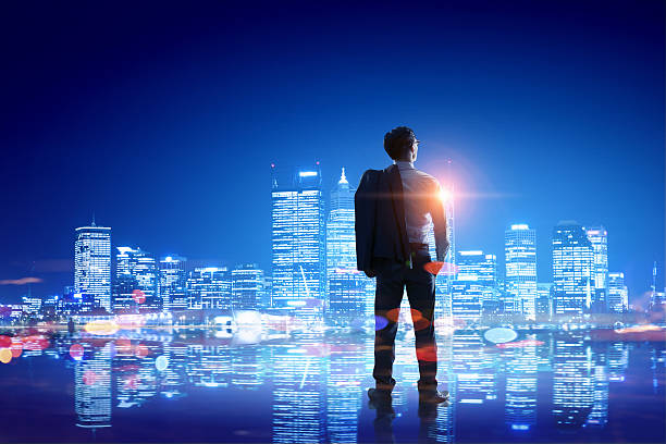 istock Businessman thinking and looking at night city . Mixed media 630619692