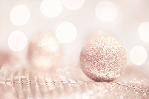 Gold Glitter Ball with Pink Bokeh Background