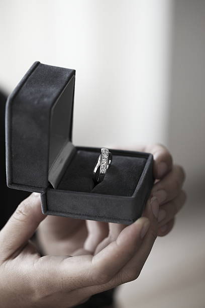 istock woman holding a box with a diamond ring 630621894