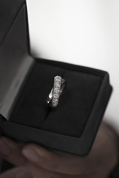 istock woman holding a box with a diamond ring 630621968
