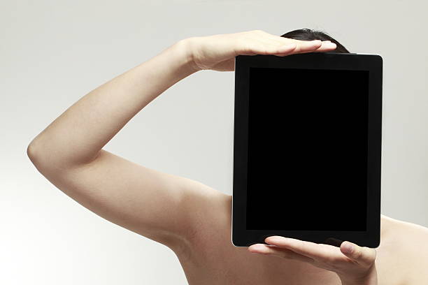 istock woman holding a tablet 630623442