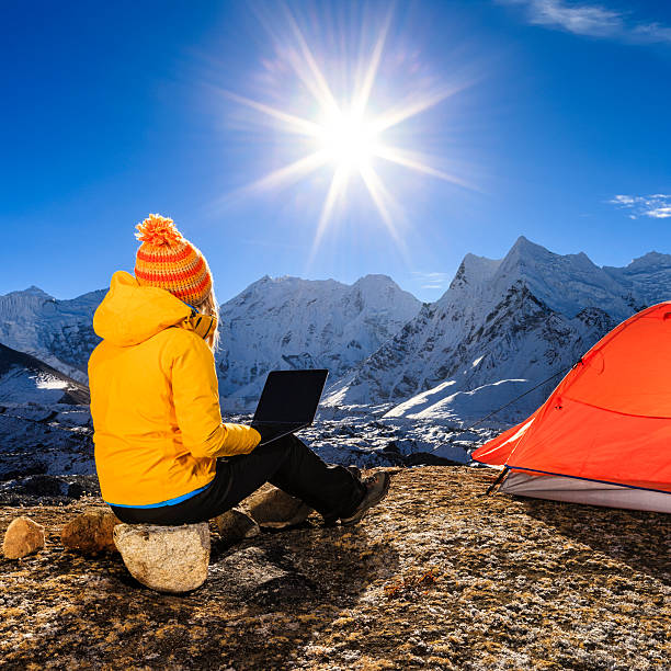 istock Young woman using laptop in Himalayas, Nepal 631181056