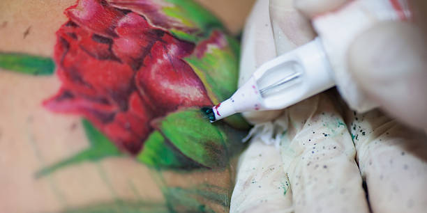istock Tattoo artist at work, close-up 631181436