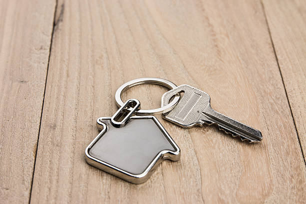 istock House-shaped key in the wood 631182840