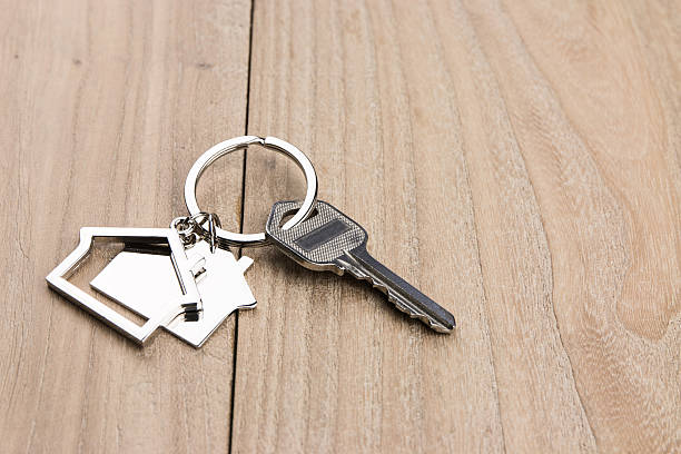 istock House-shaped key in the wood 631183026
