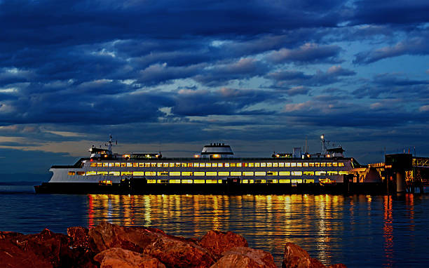 istock Car passenger transport ferry docked in pier at night 631183178