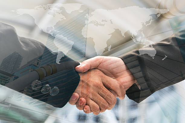 istock business people handshake, Double exposure 631183874