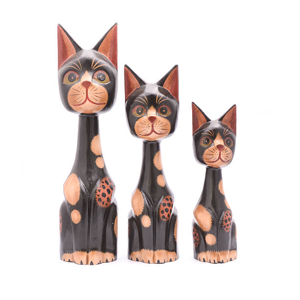 istock three wooden cats isolated on white 631662728