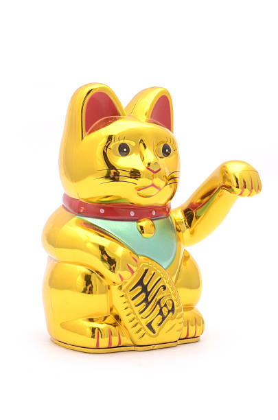 istock figurine golden cat brings good luck isolated on white 631664496