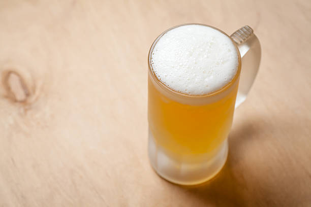 istock Mug of light beer on wood 631666218