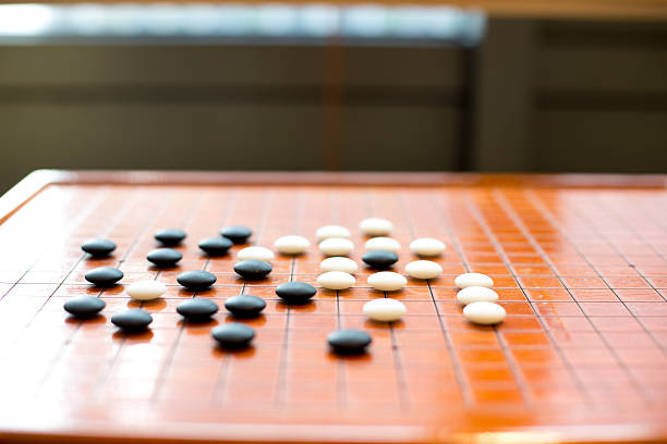 istock black and white stones on go board 631931306
