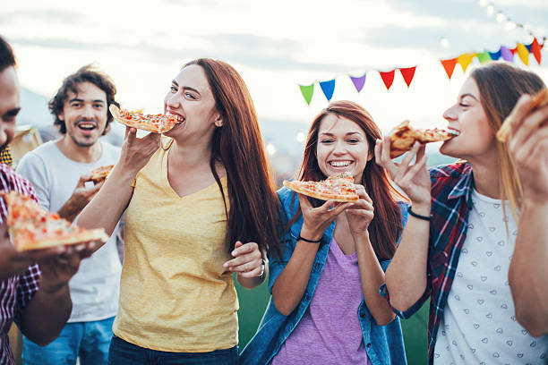 Hungry friends eating pizza