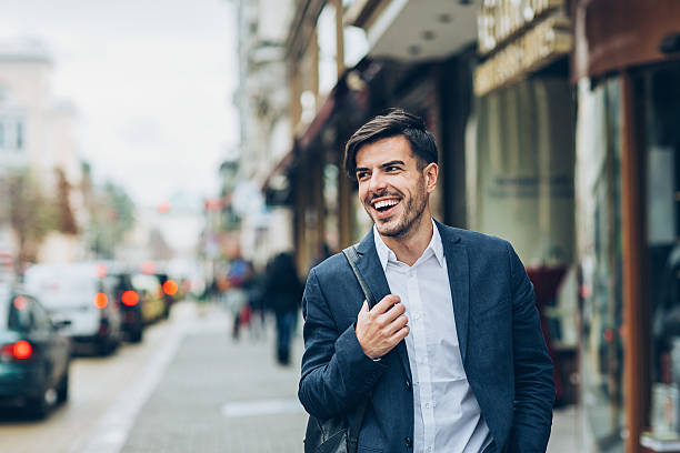 istock Smiling businessman walking at rush hour 631933320