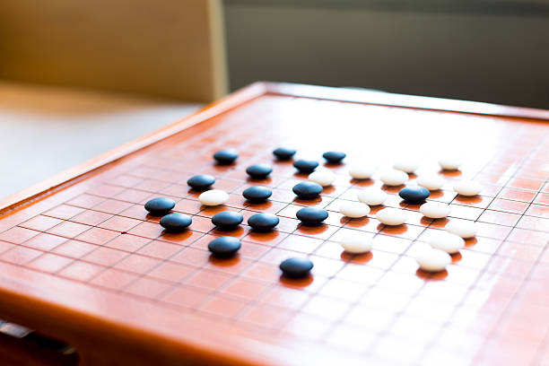 istock black and white stones on go board 631934850