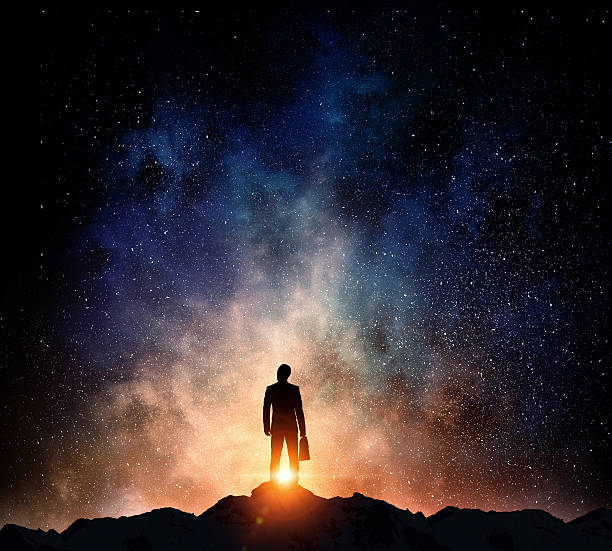 istock Businessman against starry sky . Mixed media 632216054