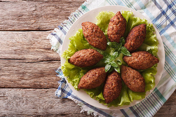 Arabic cuisine: meat appetizer kibbeh closeup on a plate Arabic cuisine: meat appetizer kibbeh close-up on a plate. Horizontal view from above lebanese culture stock pictures, royalty-free photos & images