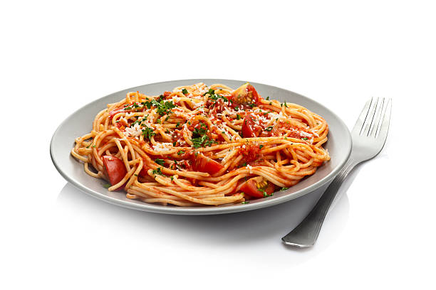 Pasta plate Pasta with tomato sauce isolated on white background. DSRL studio photo taken with Canon EOS 5D Mk II and Canon EF 100mm f/2.8L Macro IS USM Plate of Spaghetti stock pictures, royalty-free photos & images