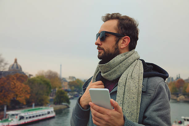 Modern guy using smartphone in the European city.