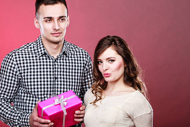 istock happy couple with gift box 632444474