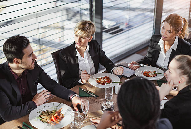 Business People Having a Meal at a Cafe Restaurant Business People at the Cafe Restaurant buffet hotel people women stock pictures, royalty-free photos & images