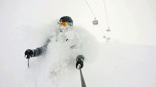 POV of skier descending though deep powder snow