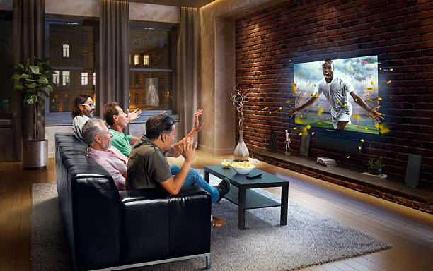 istock Adults watching Soccer game at home 634573706