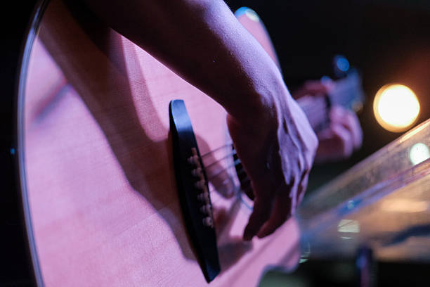 istock Closeup of blurry male hands playing the guitar 634573708