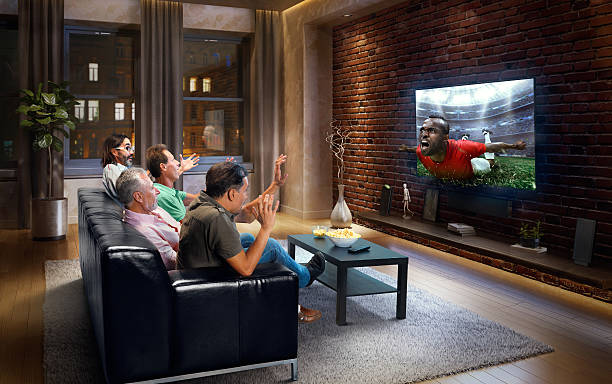 istock Adults watching Soccer game at home 634573860