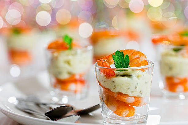 individual Cocktail Shrimp glass Shots for Christmas dinner individual Cocktail Shrimp shot glasses  with delicious homemade tartar spicy sauce decorated with parsley leaf for Christmas dinner or cocktail party, bokeh background, close-up, selective focus prawn seafood photos stock pictures, royalty-free photos & images