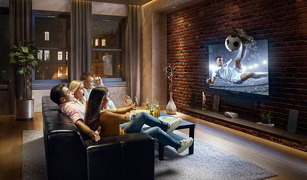 istock Couples watching very realistic Soccer game on TV 634575012
