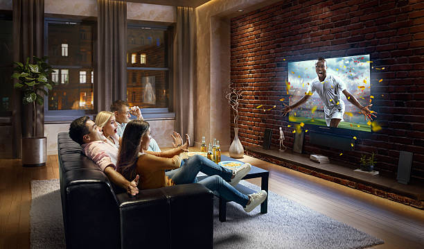 istock Couples watching very realistic Soccer game on TV 634575156