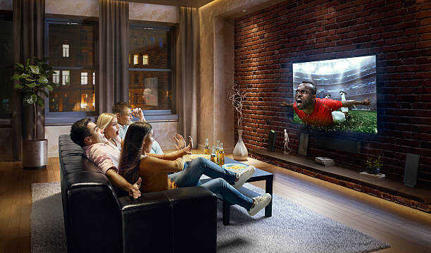 istock Couples watching very realistic Soccer game on TV 634575308