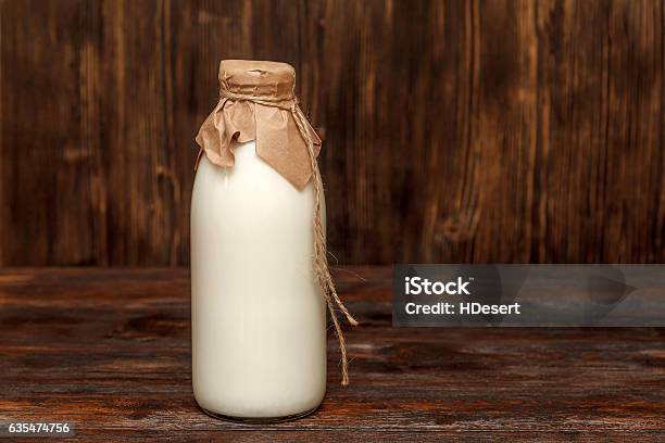 Bottle Of Milk On Rustic Wooden Table Stock Photo - Download Image Now - Milk Bottle, Bottle, Breakfast