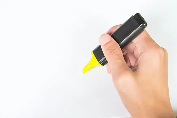Photo of ight hand use yellow highlight pen