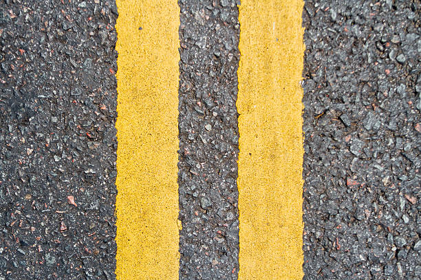 istock Asphalt road with two yellow lines seen from top 635475032