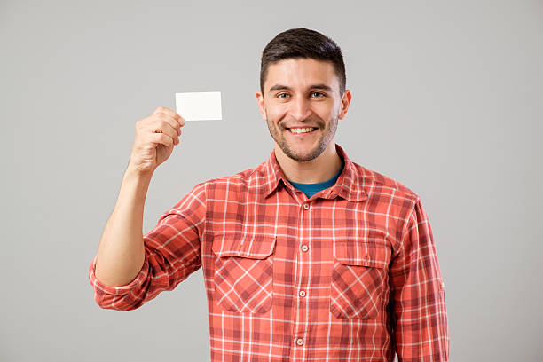 istock Man showing blank business card 635476508