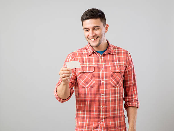 istock Young man reading business card 635476632
