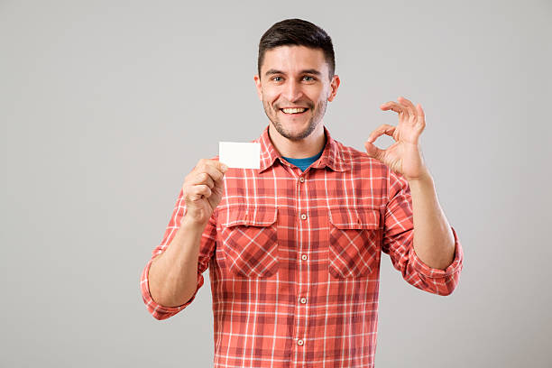 istock Man showing blank business card 635476856
