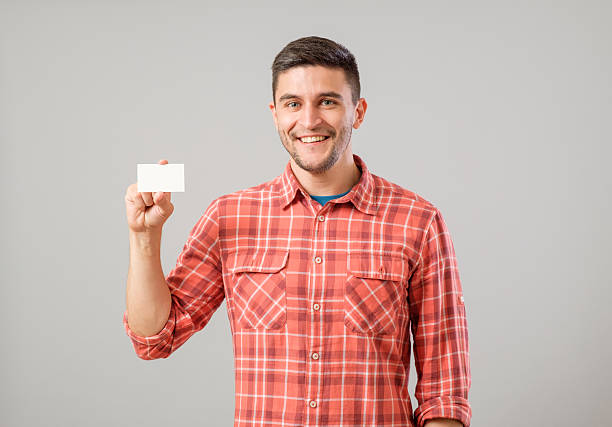 istock Man showing blank business card 635476944