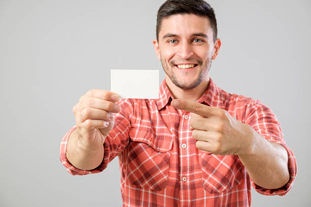 istock Man showing blank business card 635477414