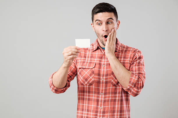istock Young man reading business card 635477500
